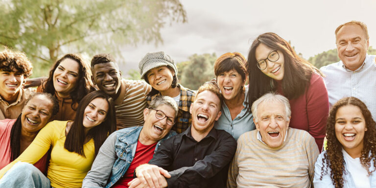 A joyful gathering of people smiling, capturing a moment of happiness and connection.